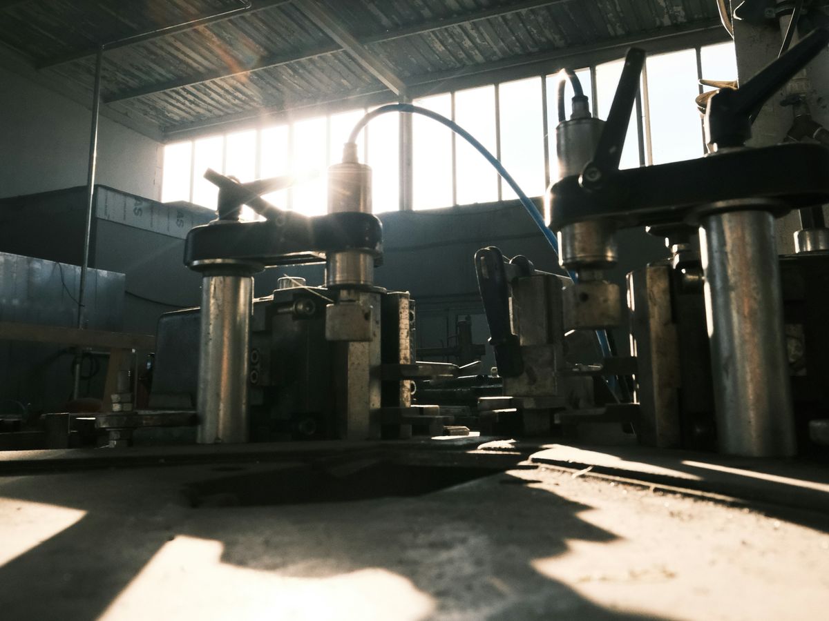 Machinery in a factory hall lit by the sun